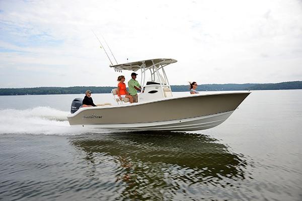 Slide: The Image of 2023 NauticStar 2302 Legacy boat cruising on a lake with passengers. - 4