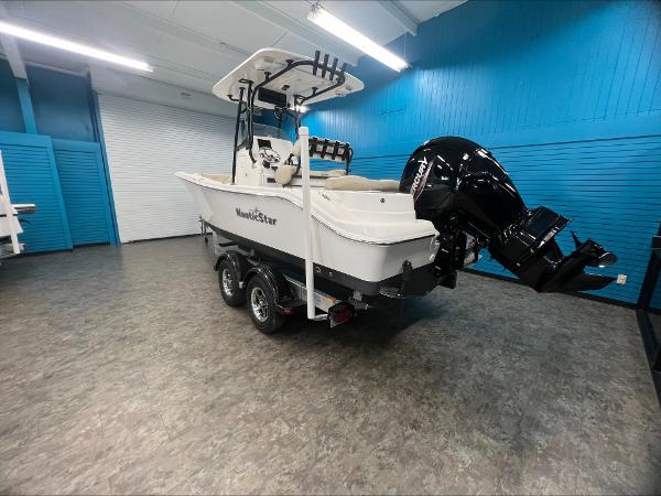 Slide: The Image of 2023 NauticStar 2302 Legacy boat on trailer in indoor showroom. - 4