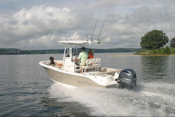 Slide: The Image of 2023 NauticStar 2302 Legacy boat cruising on a lake with passengers. - 8