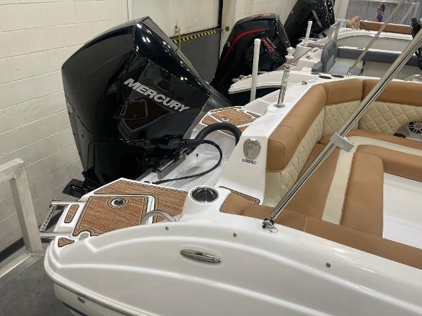 Slide: The Image of 2024 NauticStar 243 DC boat with Mercury outboard engine and tan seating. - 5
