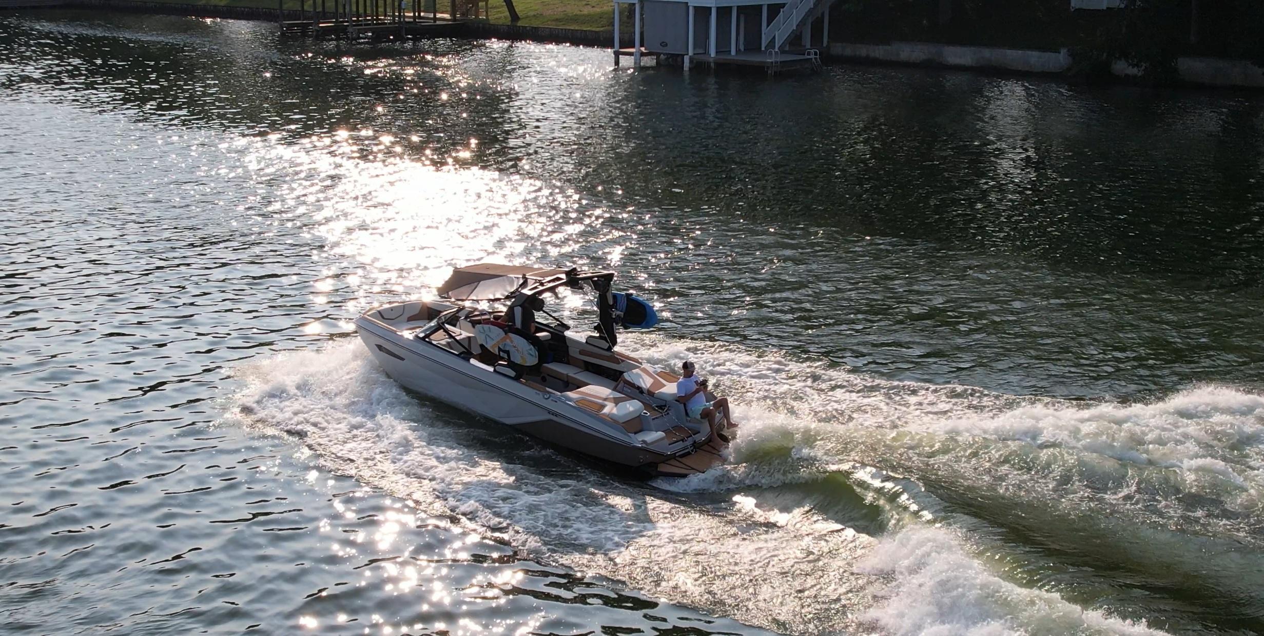 Slide: The Image of 2023 Nautique G23 boat cruising on a sunlit lake. - 22