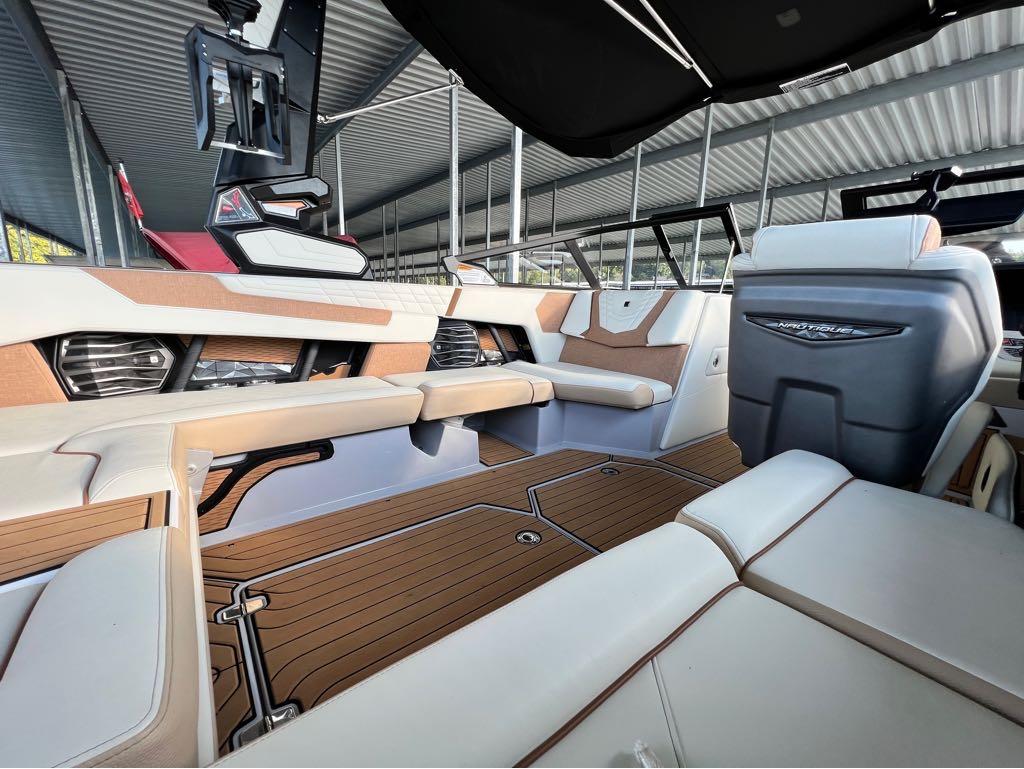 Slide: The Image of 2023 Nautique G23 boat interior with luxurious seating and modern design. - 28