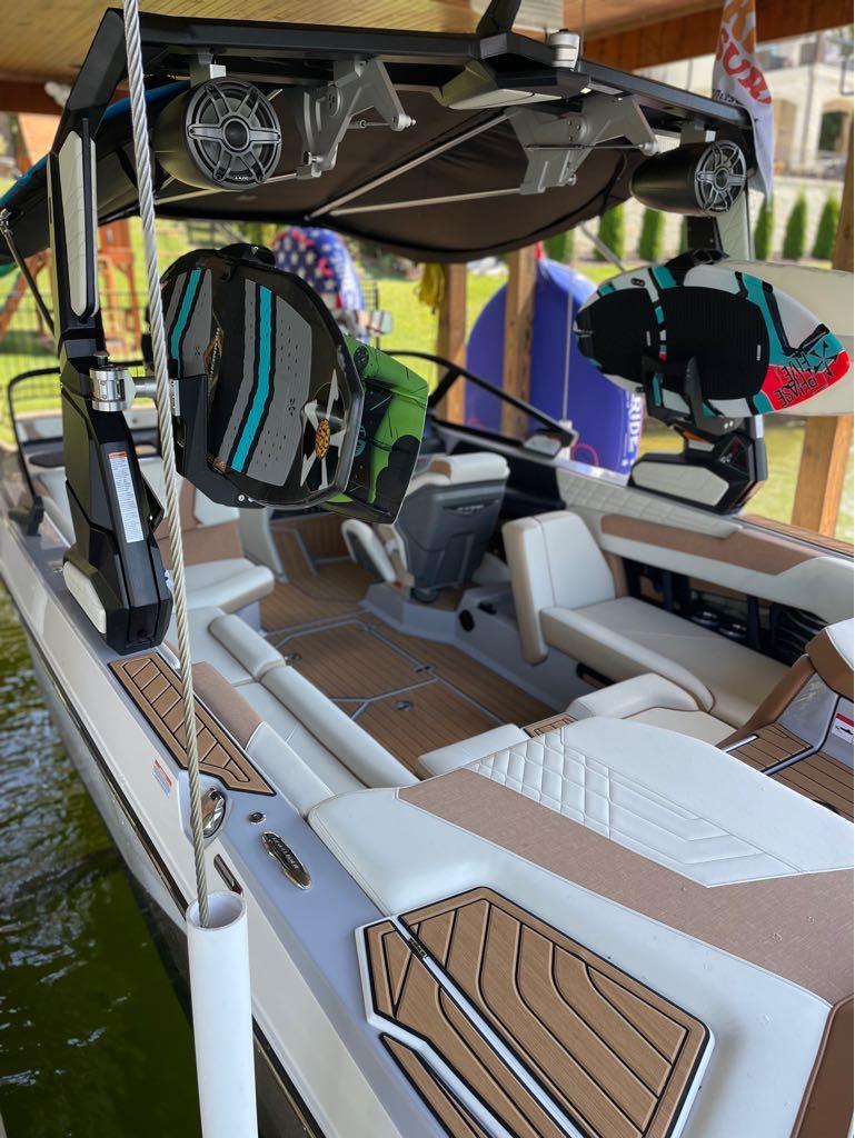 Slide: The Image of 2023 Nautique G23 boat interior with wakeboards and speakers. - 5
