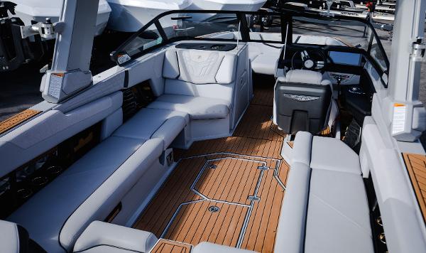 Slide: The Image of 2022 Nautique G25 boat interior with luxurious seating and teak flooring. - 10