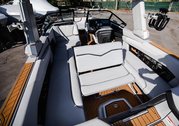 Slide: The Image of 2022 Nautique G25 boat interior with luxurious seating and modern dashboard. - 12