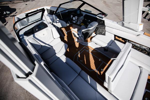 Slide: The Image of 2022 Nautique G25 boat interior with luxurious seating and modern dashboard. - 14