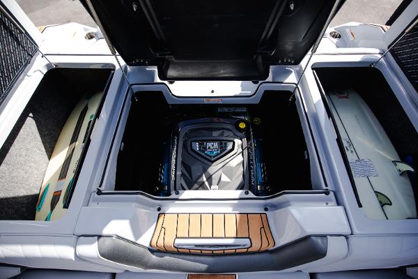 Slide: The Image of 2022 Nautique G25 boat engine compartment with surfboards. - 17