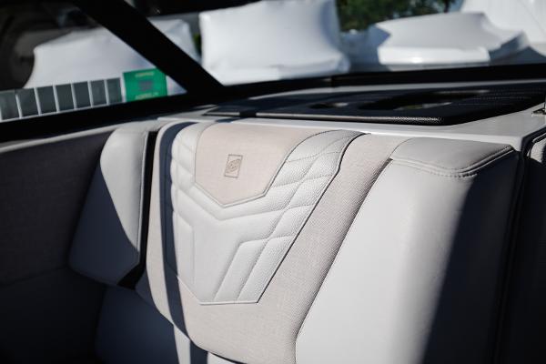 Slide: The Image of 2022 Nautique G25 boat interior with premium upholstery. - 22