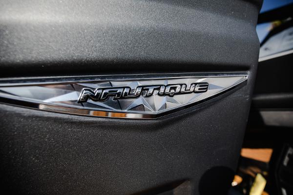 Slide: The Image of Close-up of 2022 Nautique G25 logo on a sleek black surface. - 24