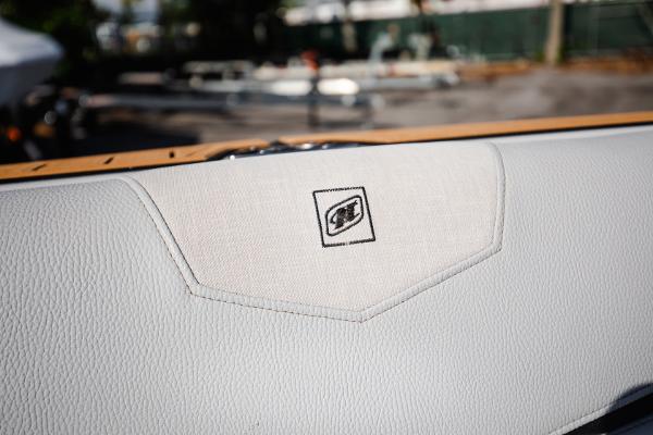 Slide: The Image of 2022 Nautique G25 boat interior detail with logo. - 25