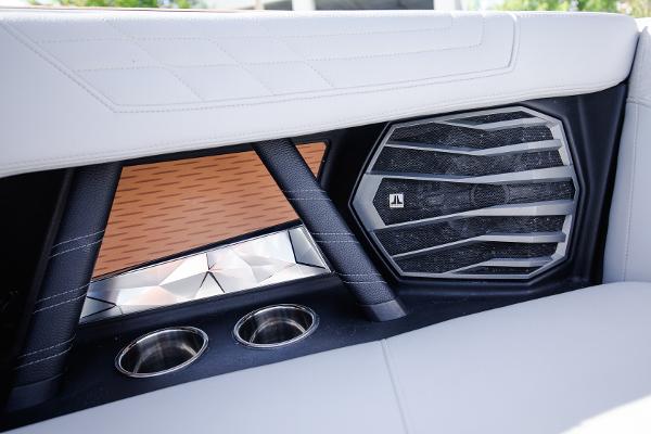Slide: The Image of 2022 Nautique G25 boat interior with JL Audio speaker and cup holders. - 26