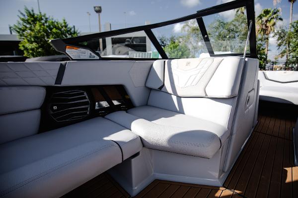 Slide: The Image of 2022 Nautique G25 boat interior with white leather seats and modern design. - 27