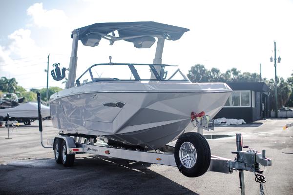 Slide: The Image of 2022 Nautique G25 boat on a trailer in a parking lot. - 3