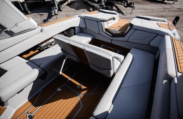 Slide: The Image of 2022 Nautique G25 boat interior with luxurious seating and teak flooring. - 36