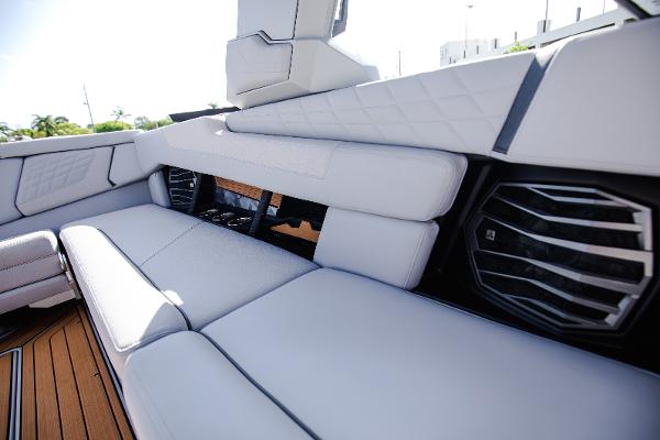 Slide: The Image of 2022 Nautique G25 boat interior with white cushioned seating and modern design. - 37