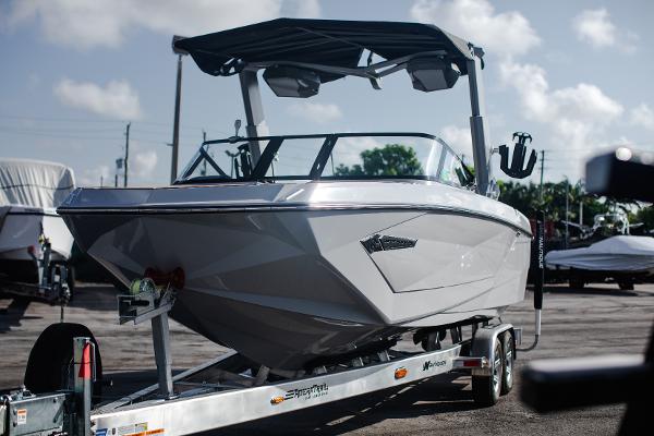 Slide: The Image of 2022 Nautique G25 boat on a trailer in a marina. - 39
