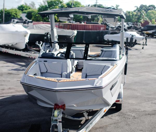 Slide: The Image of 2022 Nautique G25 boat on a trailer in a marina. - 40