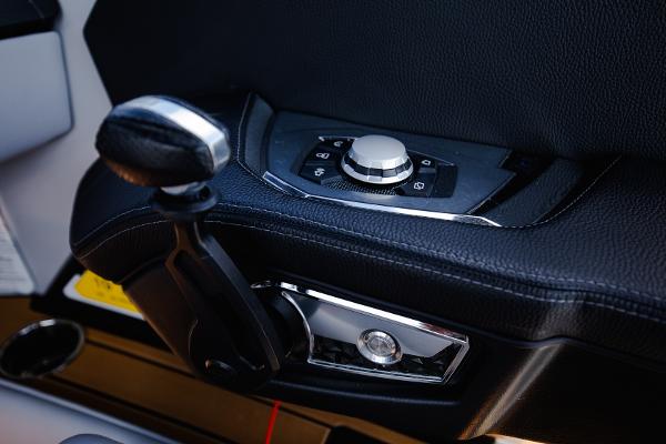 Slide: The Image of Close-up of 2022 Nautique G25 boat control panel and throttle. - 5