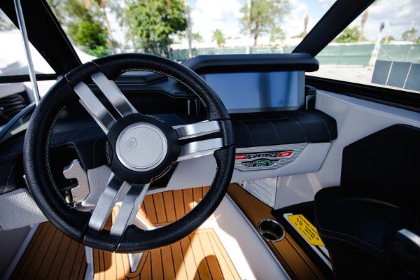 Slide: The Image of 2022 Nautique G25 boat interior with steering wheel and dashboard. - 6