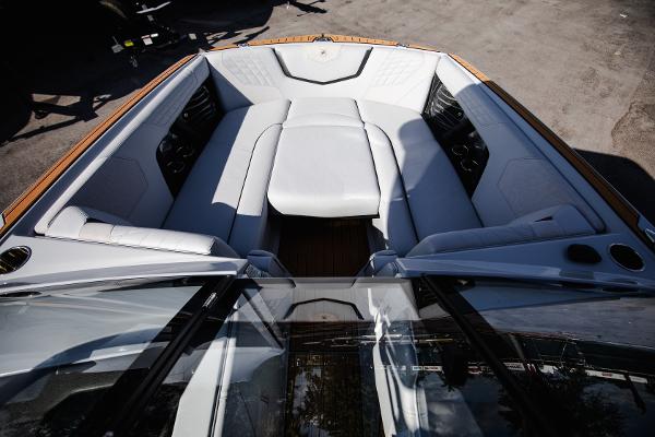 Slide: The Image of 2022 Nautique G25 boat interior with luxurious white seating. - 7