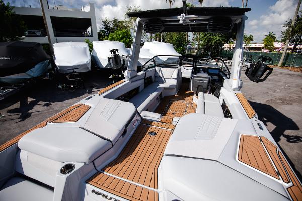 Slide: The Image of 2022 Nautique G25 boat with spacious deck and modern design. - 8