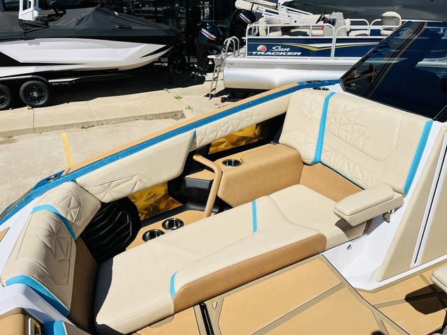 Slide: The Image of 2024 Nautique G25 Paragon boat interior with luxurious seating and cup holders. - 16
