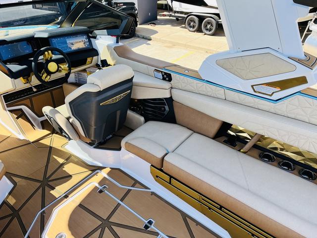 Slide: The Image of 2024 Nautique G25 Paragon boat interior with luxurious seating and modern dashboard. - 21