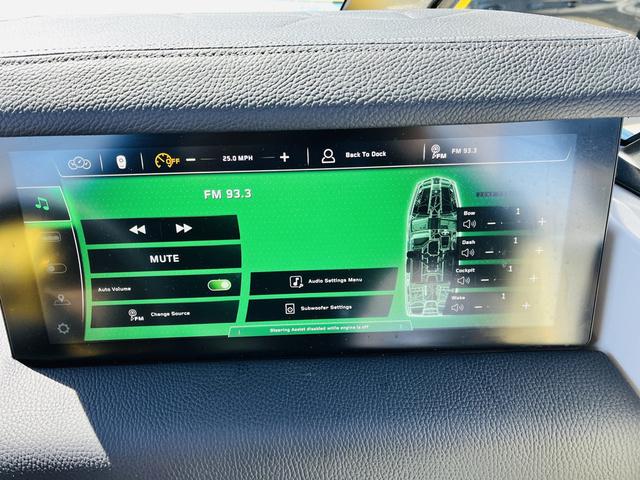 Slide: The Image of Touchscreen display in 2024 Nautique G25 Paragon showing audio controls and boat settings. - 38