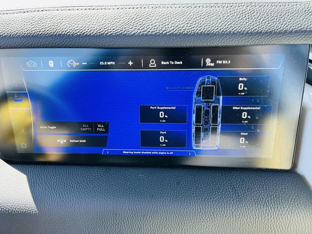 Slide: The Image of 2024 Nautique G25 Paragon dashboard display showing speed, ballast levels, and navigation controls. - 39