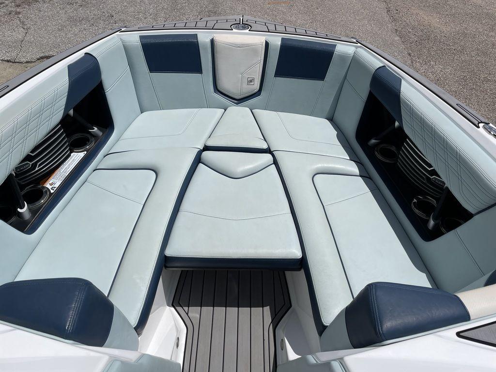 Slide: The Image of 2019 Nautique Super Air Nautique G23 boat interior with cushioned seating and cup holders. - 4