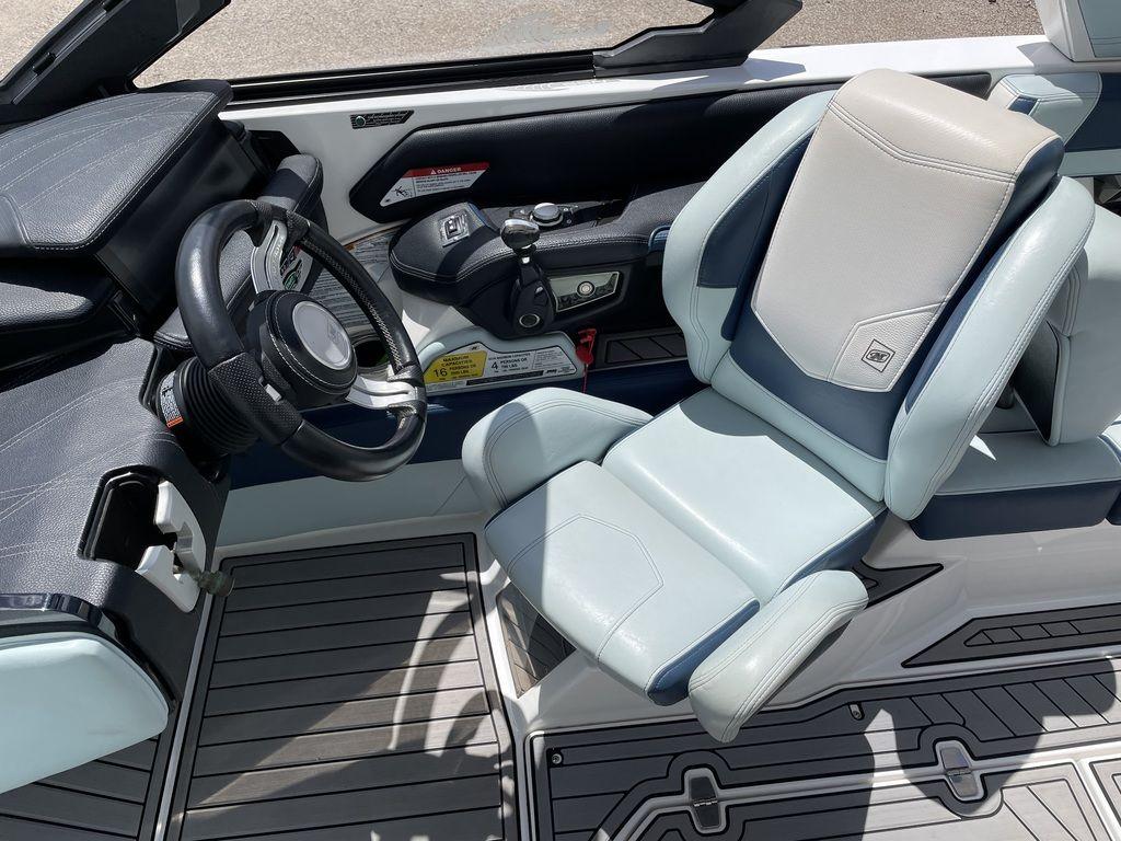 Slide: The Image of 2019 Nautique Super Air Nautique G23 cockpit with steering wheel and captain's chair. - 5