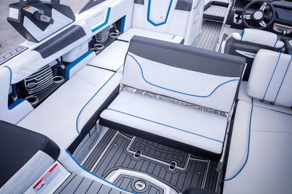 Slide: The Image of 2018 Nautique Super Air Nautique G23 Coastal Edition interior with white and blue seating. - 20