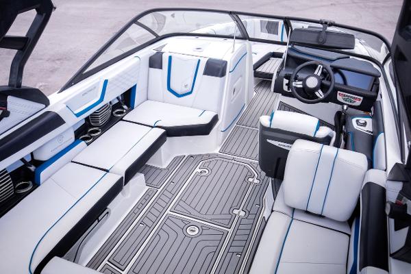 Slide: The Image of 2018 Nautique Super Air Nautique G23 Coastal Edition boat interior with modern seating and steering. - 5