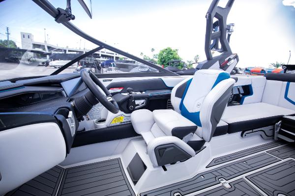 Slide: The Image of 2018 Nautique Super Air Nautique G23 Coastal Edition interior, featuring modern helm and seating. - 8