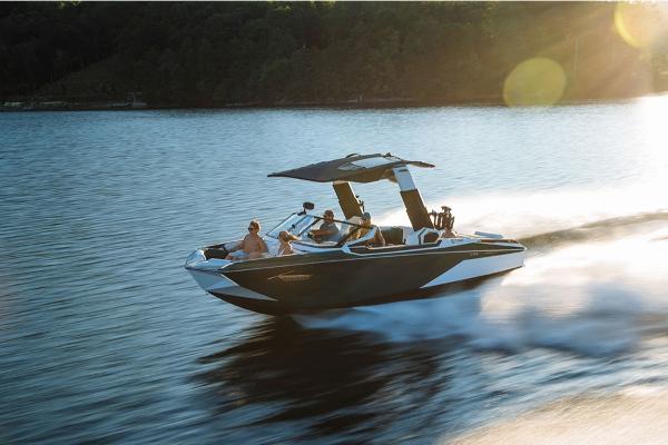 Slide: The Image of 2023 Nautique Super Air Nautique G23 Paragon speeding on a lake at sunset. - 2