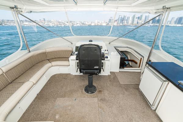 Slide: The Image of 2008 Navigator 62 Pilothouse interior with helm, seating, and ocean view. - 10