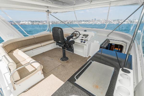 Slide: The Image of 2008 Navigator 62 Pilothouse interior with helm, seating, and ocean view. - 12