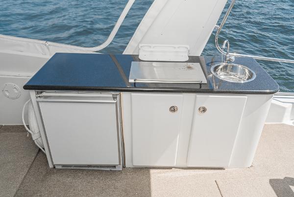 Slide: The Image of Outdoor kitchenette on 2008 Navigator 62 Pilothouse yacht with sink and grill. - 16