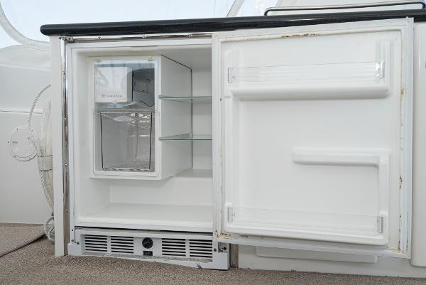 Slide: The Image of Open refrigerator on 2008 Navigator 62 Pilothouse yacht, showing interior shelves. - 19