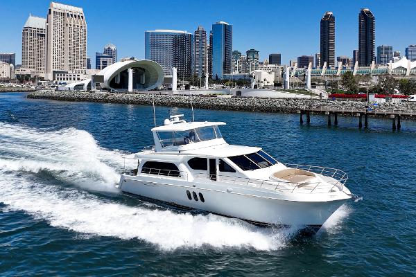 Slide: The Image of 2008 Navigator 62 Pilothouse yacht cruising near city skyline. - 2
