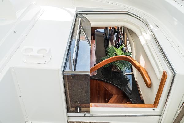 Slide: The Image of 2008 Navigator 62 Pilothouse interior staircase with wooden handrail and modern design. - 20