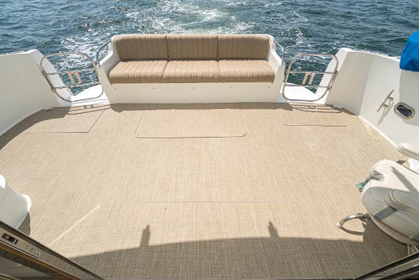 Slide: The Image of 2008 Navigator 62 Pilothouse deck with seating, overlooking ocean waves. - 21
