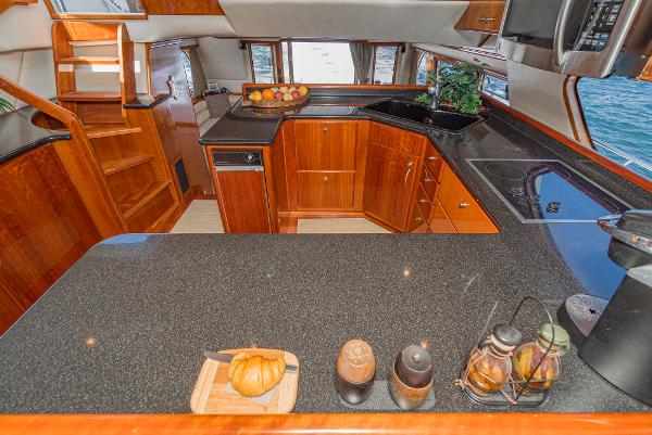 Slide: The Image of Luxurious kitchen interior of 2008 Navigator 62 Pilothouse yacht with wooden cabinetry and modern appliances. - 32