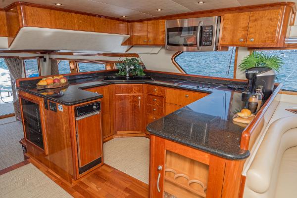 Slide: The Image of Luxurious kitchen interior of 2008 Navigator 62 Pilothouse yacht with wooden cabinetry and modern appliances. - 34