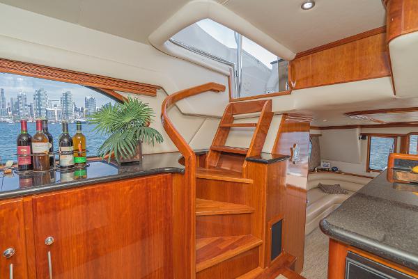 Slide: The Image of Luxurious 2008 Navigator 62 Pilothouse interior with wooden stairs and city skyline view. - 35