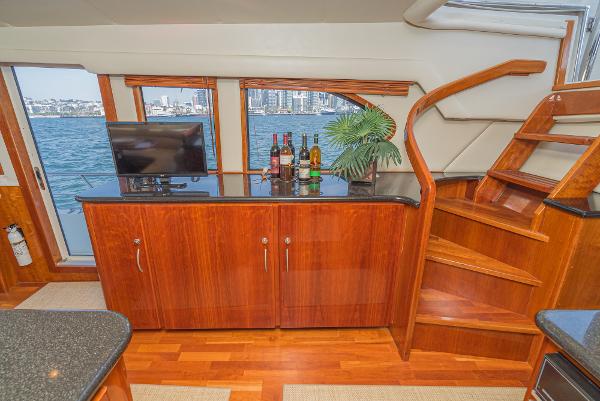 Slide: The Image of Luxurious interior of 2008 Navigator 62 Pilothouse yacht with wooden cabinetry and waterfront view. - 36