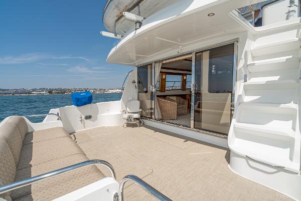 Slide: The Image of 2008 Navigator 62 Pilothouse yacht deck with seating, stairs, and ocean view. - 4