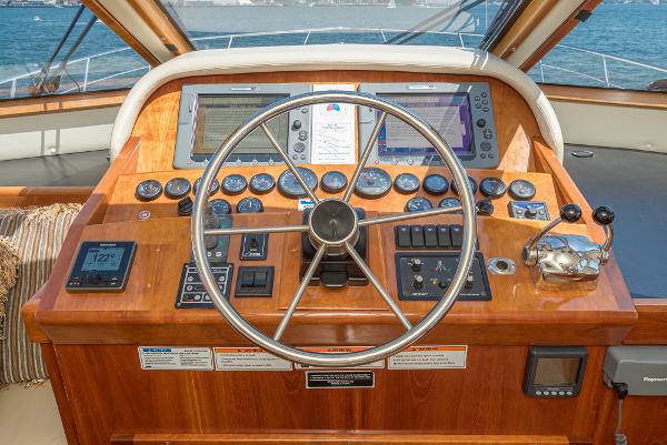 Slide: The Image of Navigator 62 Pilothouse 2008 helm with wooden dashboard and navigation instruments. - 41