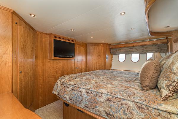 Slide: The Image of Luxurious bedroom interior of 2008 Navigator 62 Pilothouse yacht with wood paneling and cozy bedding. - 44