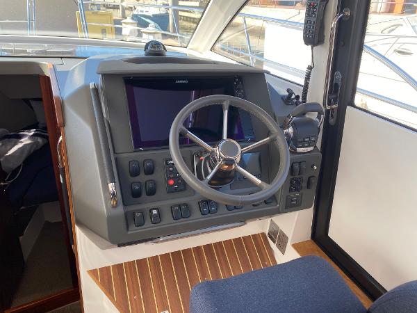 Slide: The Image of Nimbus 305 Coupe 2025 boat cockpit with steering wheel and control panel. - 3